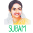 A colorful illustrated portrait of a smiling South Indian woman wearing jasmine flowers in her hair, a yellow saree, and gold jewelry, with the word ‘SUBAM’ written below in green stylized text.